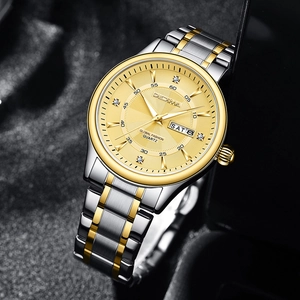 Close-up of a two-tone steel watch in a black box showing date and weekday display
