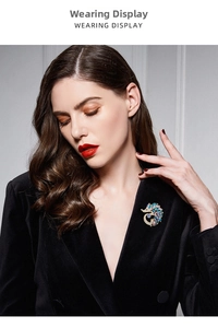 Close-up of a colorful rhinestone hedgehog brooch worn on a black velvet blazer