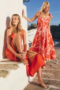 Detail of elegant orange floral sleeveless backless dress with layered bohemian skirt