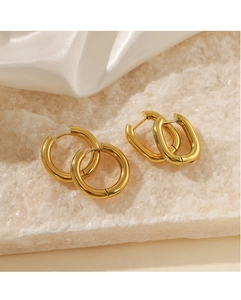 Detail of round and rectangular 18K gold plated stainless steel earrings on white silk