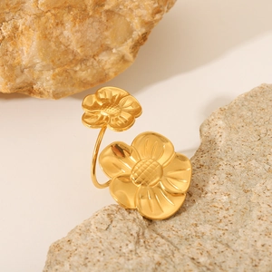 French vintage style gold flower ring in titanium steel displayed on a natural stone base