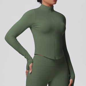 Detailed view of the thumb hole cuffs and ribbed fabric on a green zip-up yoga jacket