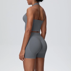 Side view of seamless knitted sports set showing lifting texture on dark gray shorts