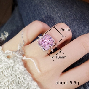 Close-up of pink square gemstone ring on finger with 13x10mm size and 5.5g weight info