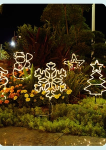 Outdoor solar Christmas lights with snowflake and star shapes in warm white glow