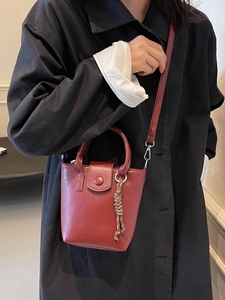 Vintage red leather mini bucket bag with single handle and detachable strap for women