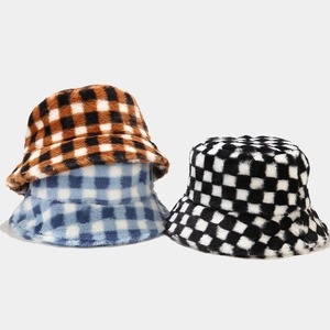 Three plush checkerboard bucket hats in brown, blue and black for winter warmth