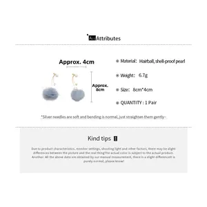 Detail view of blue grey fur ball earrings with pearls and silver needles specification