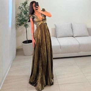Sleeveless bronze metallic pleated maxi dress with deep V-neck and waist cutouts
