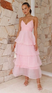 Detailed view of layered pink organza ruffles and thin shoulder straps on evening gown
