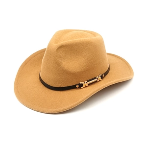Detail of camel wool felt western hat featuring black leather band and gold buckle