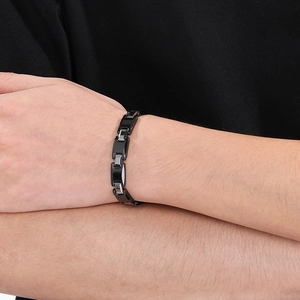 Detailed view of polished black tungsten steel magnetic link bracelet on a wrist