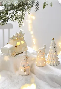 Ceramic Christmas figurine set with star cutouts and warm glowing LED lights