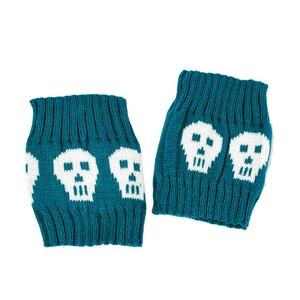 Detailed knit texture of teal leg warmers featuring white skull patterns and ribbed cuffs