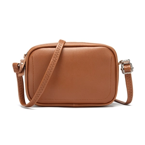 Detailed view of dark brown crossbody camera bag with Z-stitch adjustable strap and silver buckle