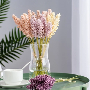 Detailed close-up of artificial wheat ears in pink and purple colors for home decoration