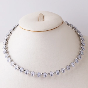 Detail showing elegant silver choker with clear oval gemstones on a jewelry bust