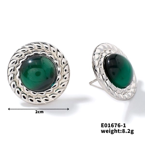 Detail view of 2cm dark green gemstone stud earrings with silver textured edges