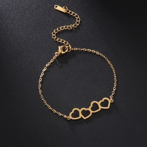 Detailed shot of four interlocking hollow hearts on a gold adjustable steel bracelet