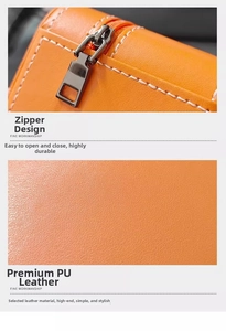 Detail of premium orange PU leather texture and smooth gunmetal zipper on travel watch box