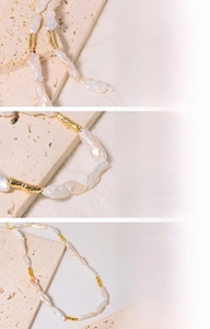 Detailed macro view of baroque freshwater pearls and 18K gold plated hardware textures