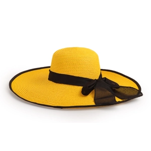 Detailed macro view of yellow straw hat with wide brim and elegant black ribbon bow