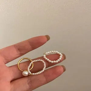 Three-piece stackable freshwater pearl ring set with gold elastic band for women