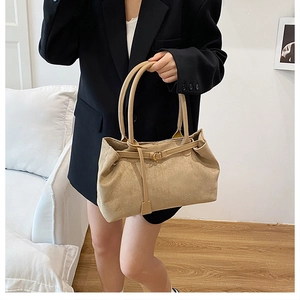 Detail of khaki suede tote bag with slim shoulder straps and vintage matte finish texture