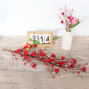 Detail of red heart-shaped foam berries and branches for Valentine's home decoration