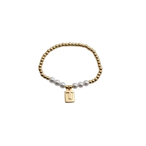 Close-up of gold beads and white pearls bracelet with a rectangular 'U' letter pendant