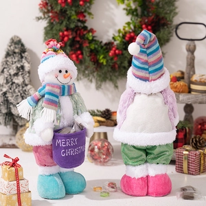 Detail of knit Christmas snowman dolls with colorful scarves and Merry Christmas gift bag