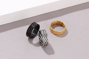 Macro detail of three-color stainless steel rings with classic quilted fishbone pattern