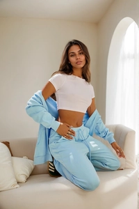 Detail of white slim-fit short T-shirt paired with light blue hooded tracksuit set