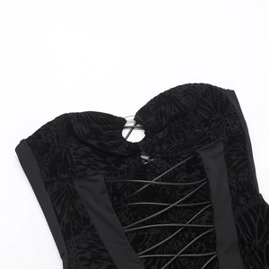 Detail of black butterfly flocking fabric with lace-up straps and metallic eyelets