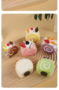 Detailed view of six artificial Swiss rolls with realistic cream and fruit on wood tray