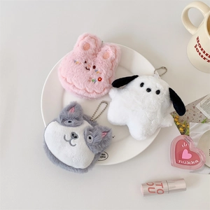 Cute plush bunny puppy and cat pocket mirror keychains displayed on a white plate