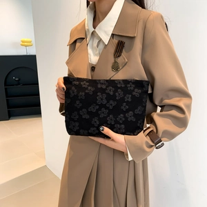Minimalist black floral embossed clutch handbag with 3D flower pattern for women