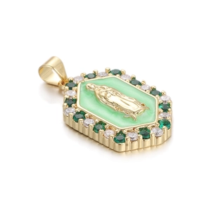 Detailed macro view of gold hexagon pendant with green enamel and religious figure icon