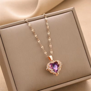Rose gold heart pendant necklace with purple gemstone on a chic beige gift box