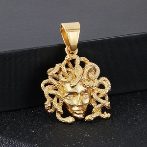 Macro shot of detailed golden Medusa head pendant with intricate serpent hair textures