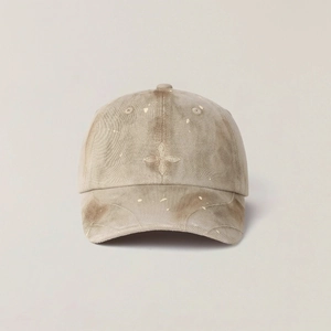 Detail of cross star embroidery on vintage washed corduroy baseball cap with tie-dye finish