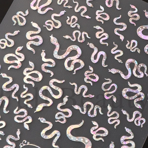 Detail of snake pattern nail art stickers with laser holographic iridescent finish