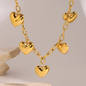 Elegant gold heart pendant necklace with five charms on a classic O-chain link