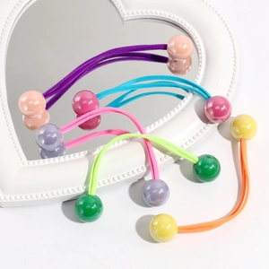 Detail of colorful flower elastic hair ties on a heart mirror in bright candy colors
