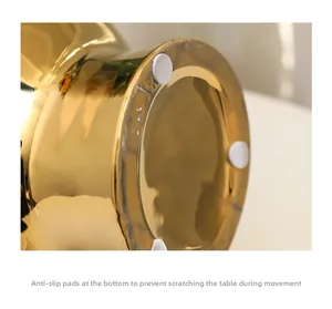 Detailed macro view of gold ceramic vase base featuring white anti-slip protective pads