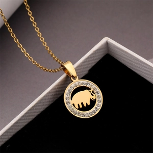 Detailed view of a gold elephant pendant with sparkling crystal rhinestones in a gift box