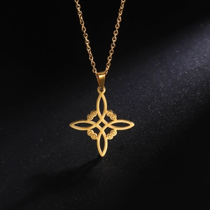Gros plan d'un collier pendentif nœud de sorcière celtique doré sur fond texturé noir