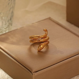 Golden wrap snake ring with detailed scale texture in a luxurious minimalist style