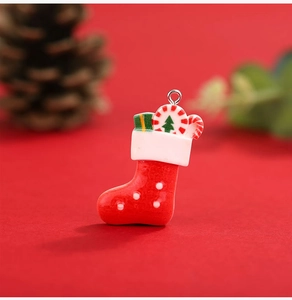 Close-up of a resin red Christmas stocking pendant with gift box and candy cane detail