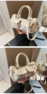 Detail of cream patent leather Boston bag with silver hardware and front pockets